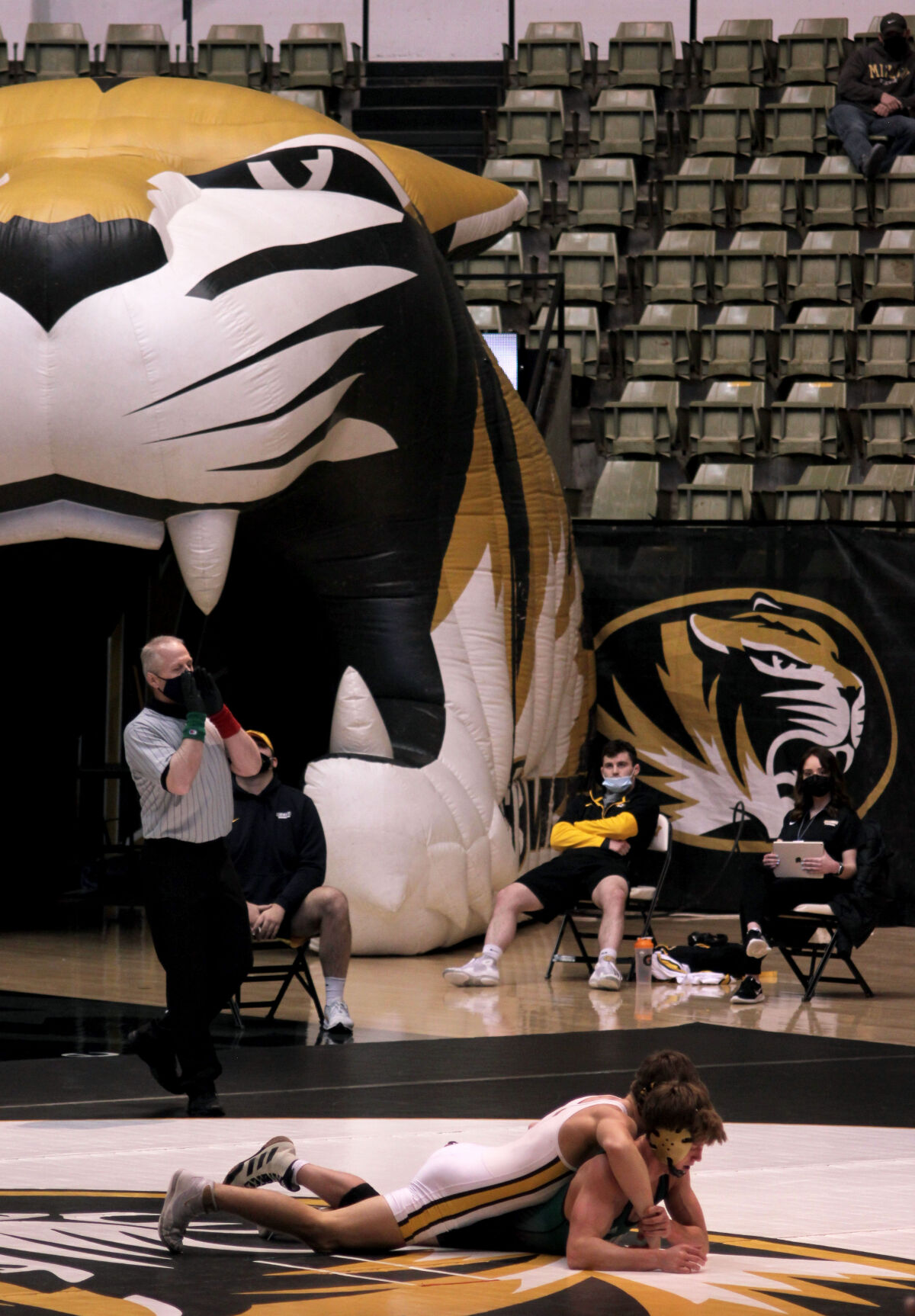 Staff and spectators watch the MU wrestling dual